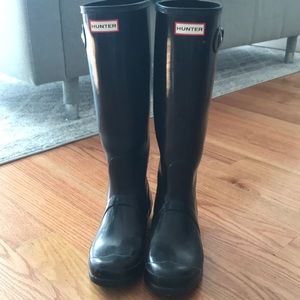 Tall glossy black hunter boots